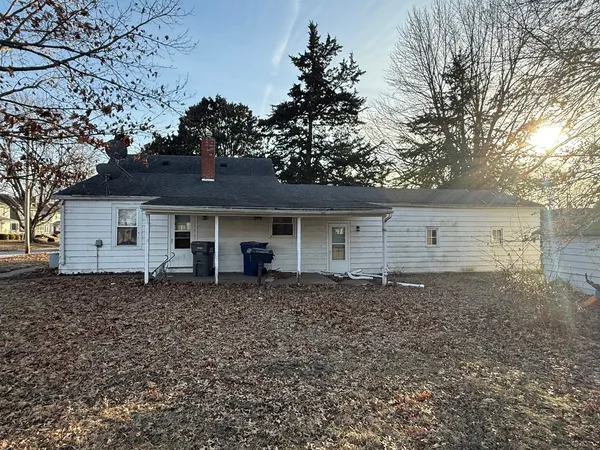 a view of a yard with wooden fence