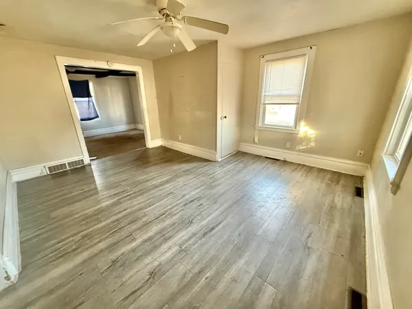 wooden floor in an empty room with a window