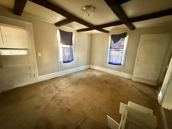 a kitchen with stainless steel appliances a refrigerator a stove a sink and a window