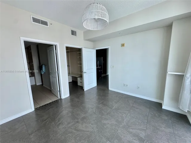 a view of a hallway with wooden shelves