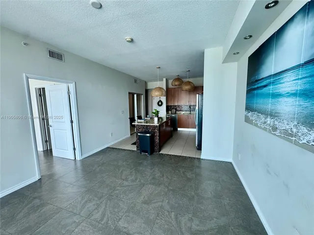 a view of a livingroom with furniture and a flat screen tv