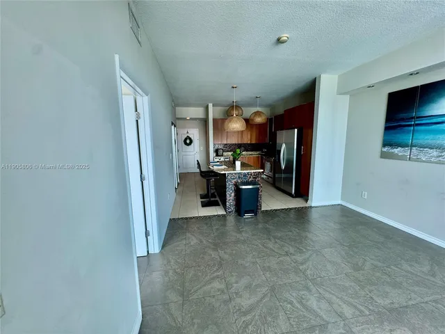 a view of a room with furniture and a flat screen tv