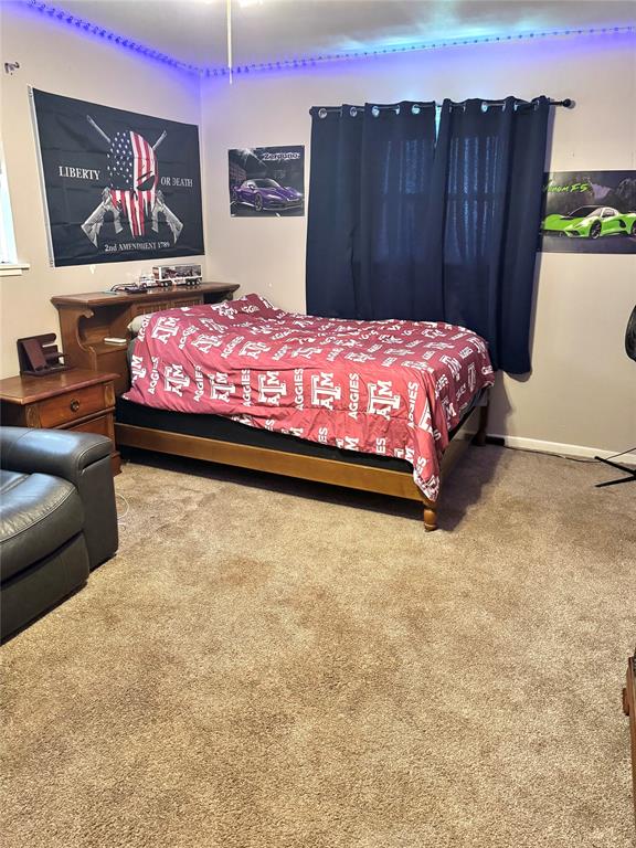 705 Loop Road Quanah, TX 79252 - Photo 13 of 14 a bedroom with a bed and wall painting