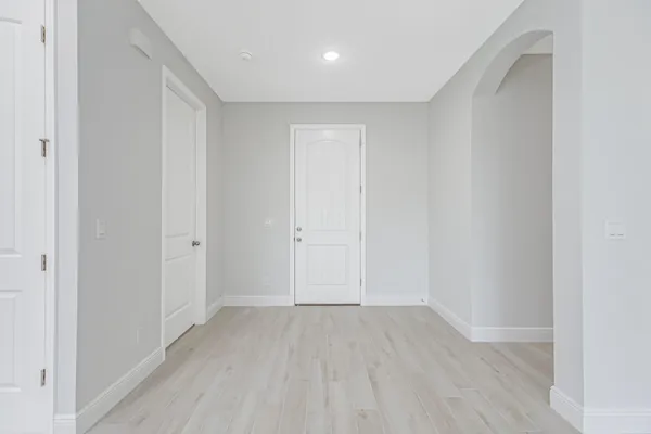 a view of hallway with wooden floor