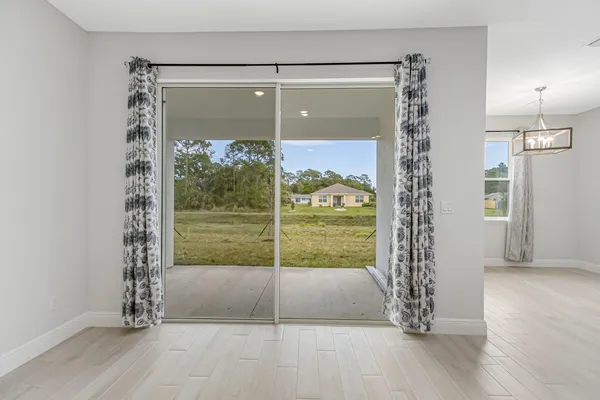 a view of a room with wooden floor and a fireplace
