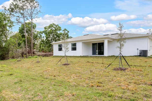 a view of a house with a backyard