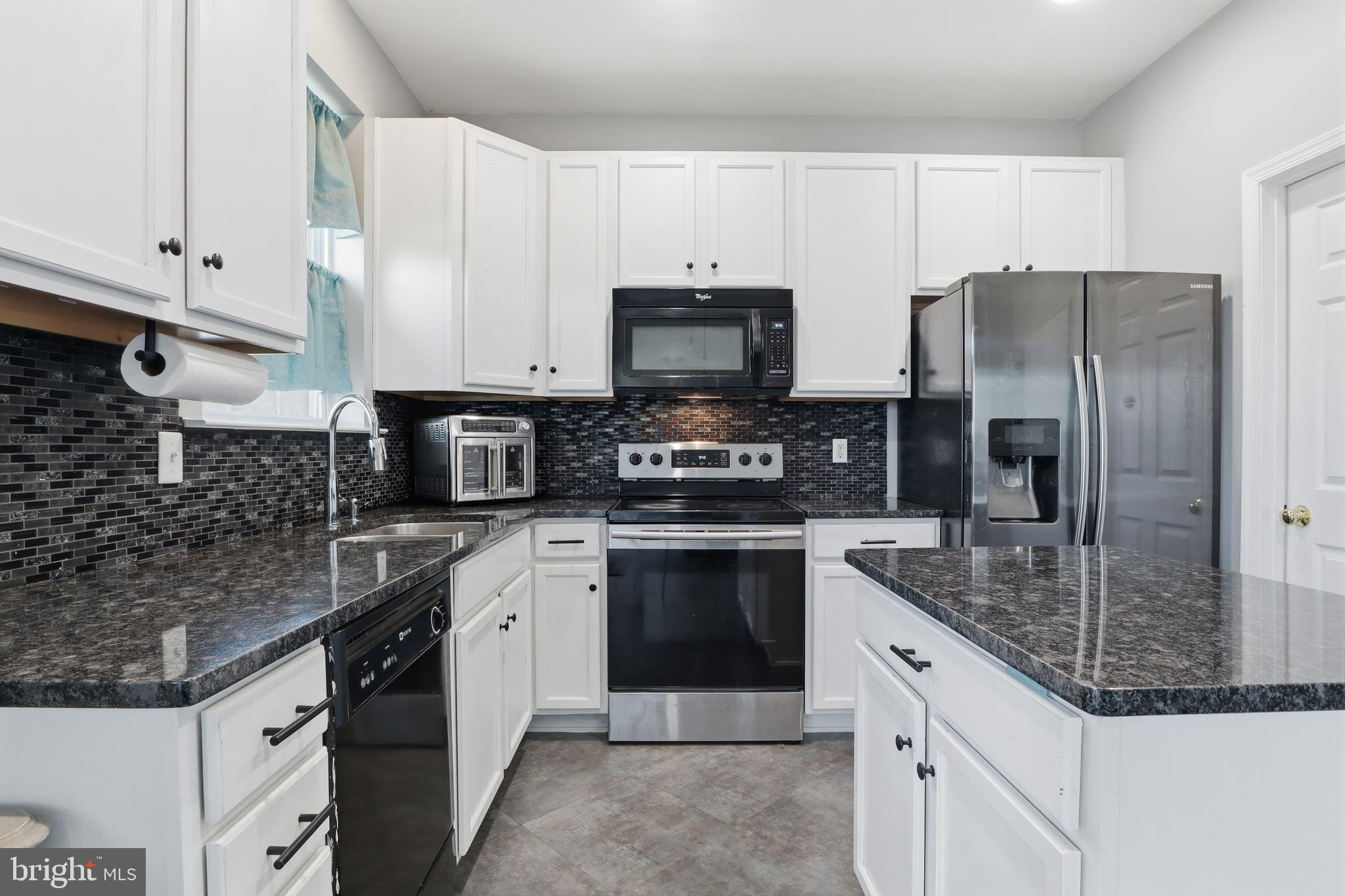 348 Cape Climb York, PA 17408 - Photo 5 of 29 a kitchen with stainless steel appliances granite countertop a refrigerator a stove a sink and white cabinets