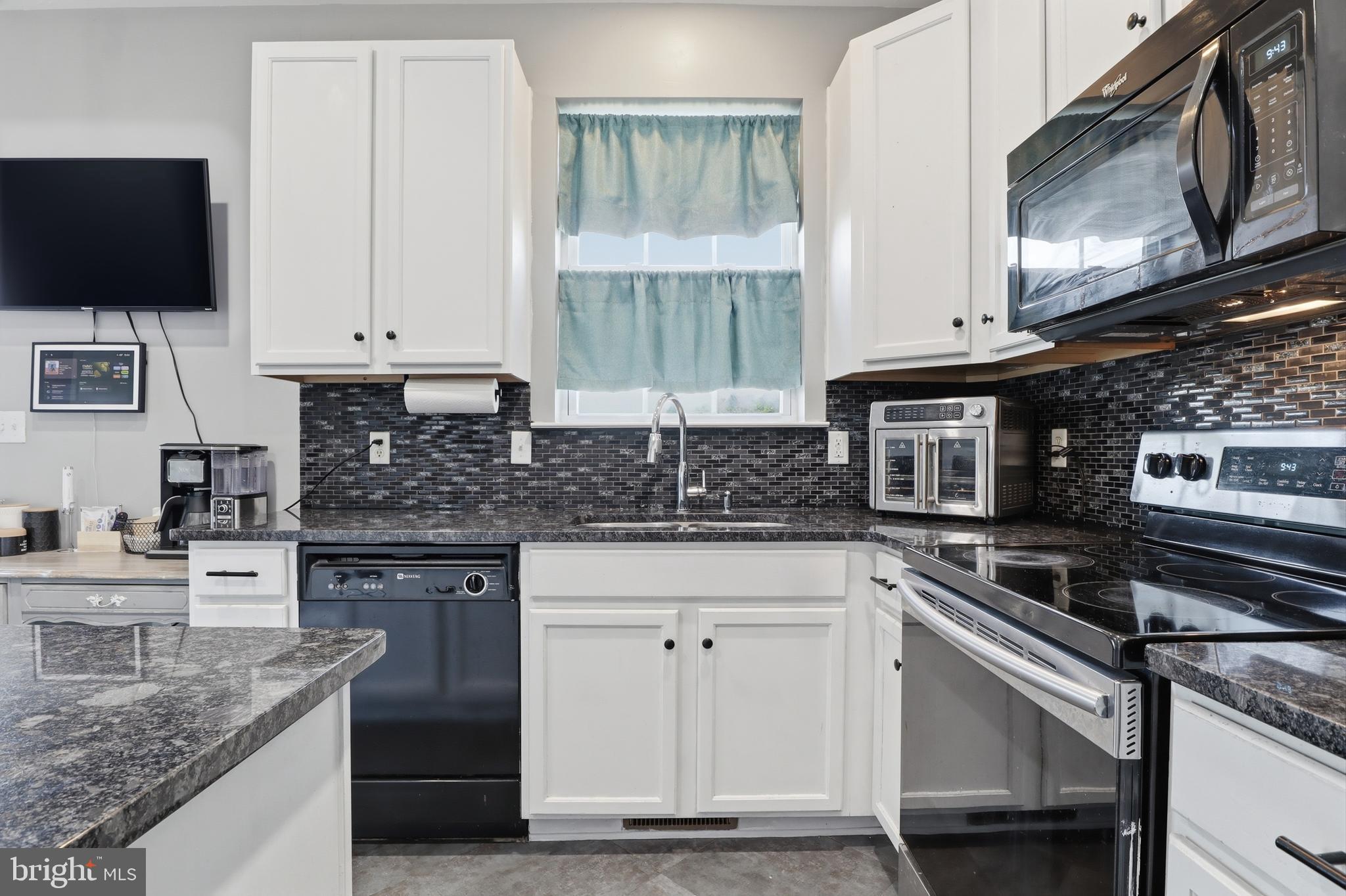 348 Cape Climb York, PA 17408 - Photo 6 of 29 a kitchen with stainless steel appliances granite countertop a stove a sink and a microwave
