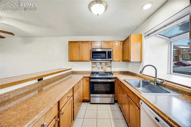 a kitchen with a stove and a sink