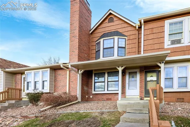 a view of a brick house with windows