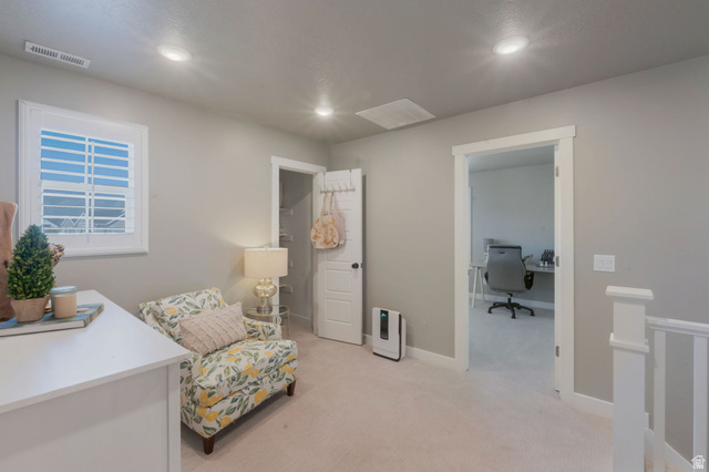 2319 North 3370 West Lehi, UT 84048 - Photo 24 of 30 Neutral-toned wall paint with recessed lighting, white window shutters, a doorway leading to an additional space, a white staircase railing, and light-colored carpeting