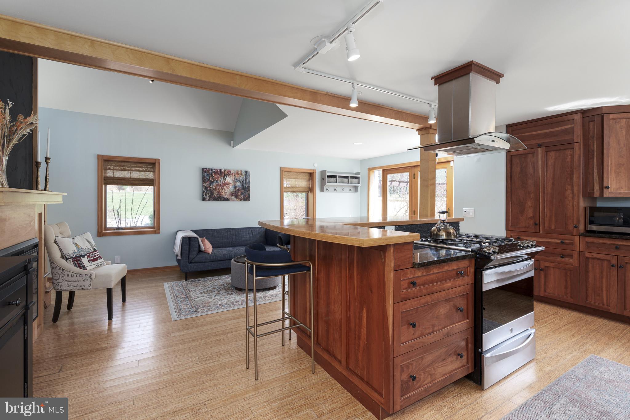 298 Hopewell Amwell Road Hopewell, NJ 08525 - Photo 21 of 51 a kitchen with stainless steel appliances granite countertop a stove top oven a refrigerator a dining table and chairs with wooden floor