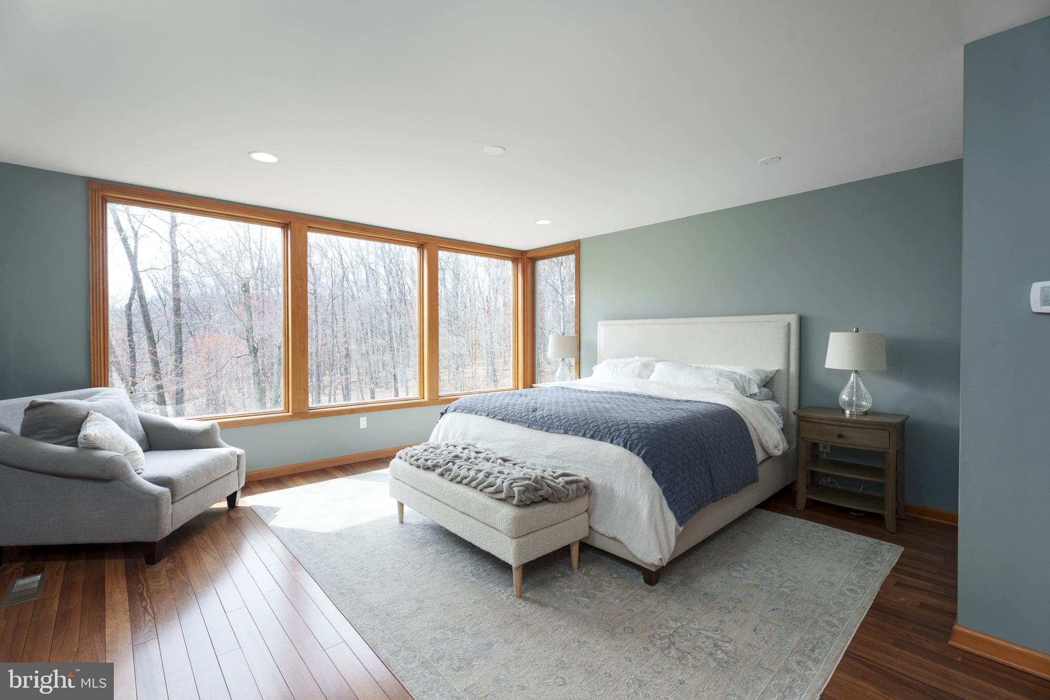 298 Hopewell Amwell Road Hopewell, NJ 08525 - Photo 26 of 51 a spacious bedroom with a bed and a couch with wooden floor