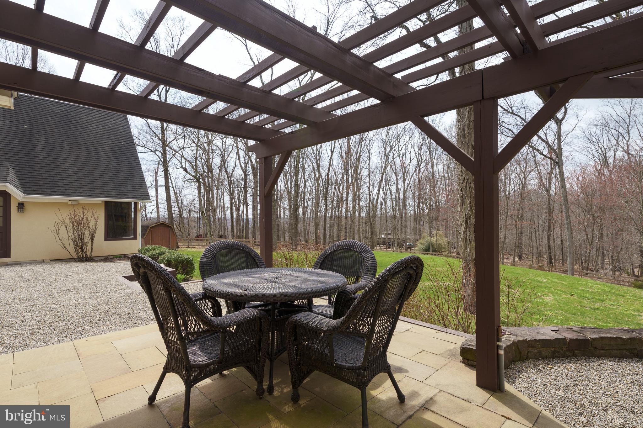 298 Hopewell Amwell Road Hopewell, NJ 08525 - Photo 41 of 51 a view of a patio with a backyard table and chairs