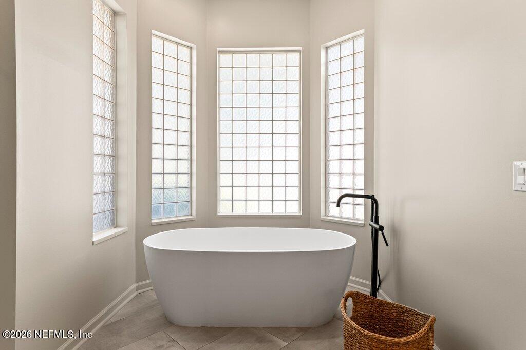 205 Royal Tern Road North Ponte Vedra Beach, FL 32082 - Photo 28 of 85 a bathroom with a bathtub and window