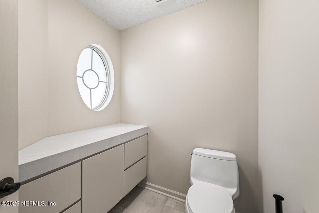 205 Royal Tern Road North Ponte Vedra Beach, FL 32082 - Photo 30 of 85 a bathroom with a toilet a sink and a mirror