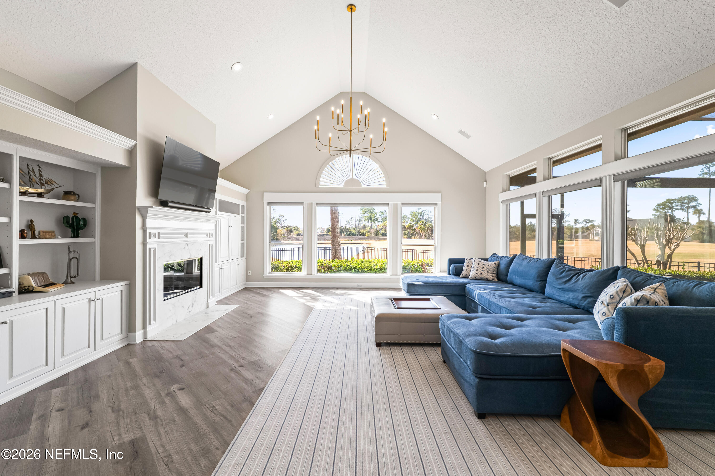 205 Royal Tern Road North Ponte Vedra Beach, FL 32082 - Photo 59 of 85 a living room with furniture a fireplace and a flat screen tv