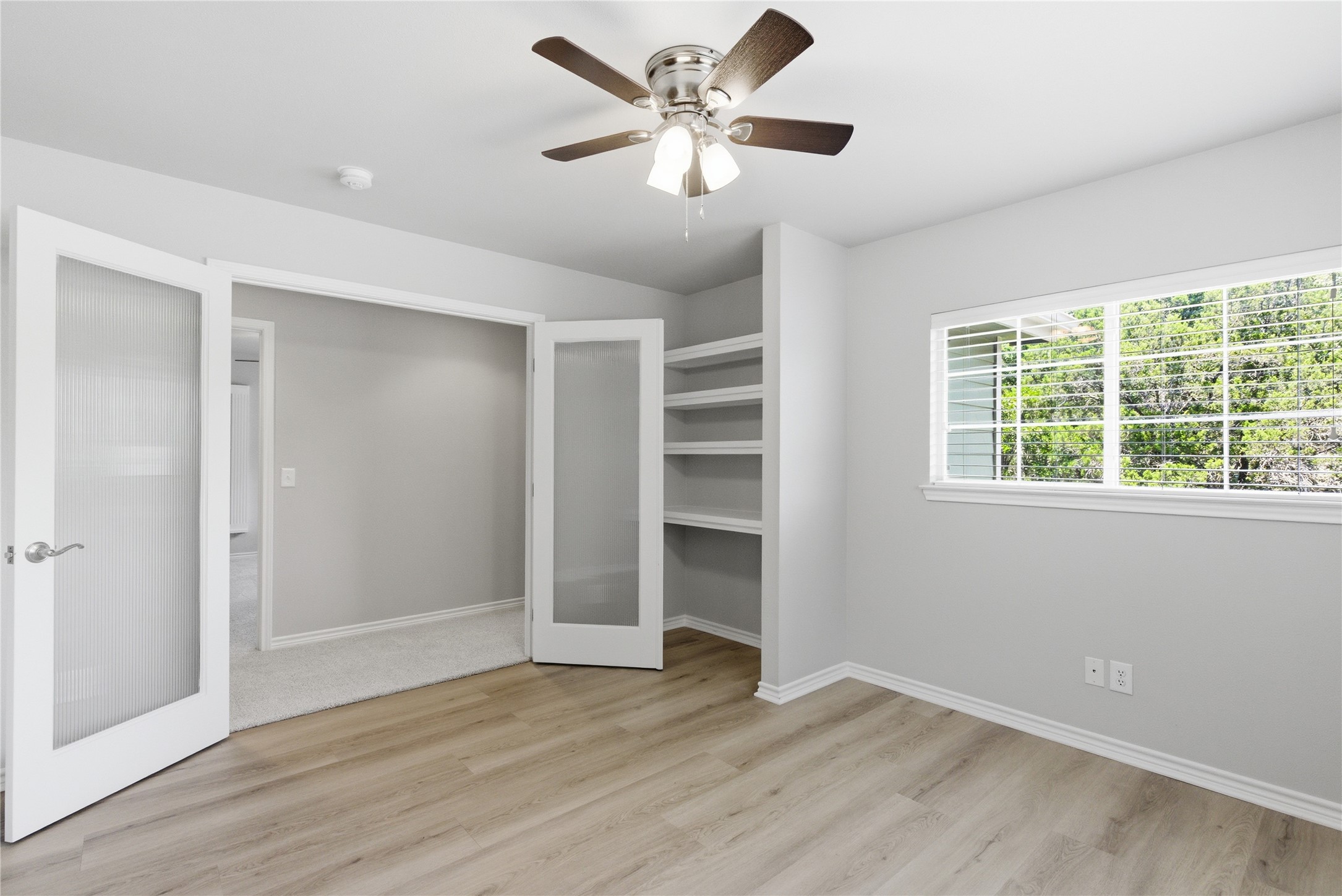 1204 Orlando Road Austin, TX 78733 - Photo 34 of 40 A versatile space features modern wood flooring, abundant natural light, and convenient built-in shelving.