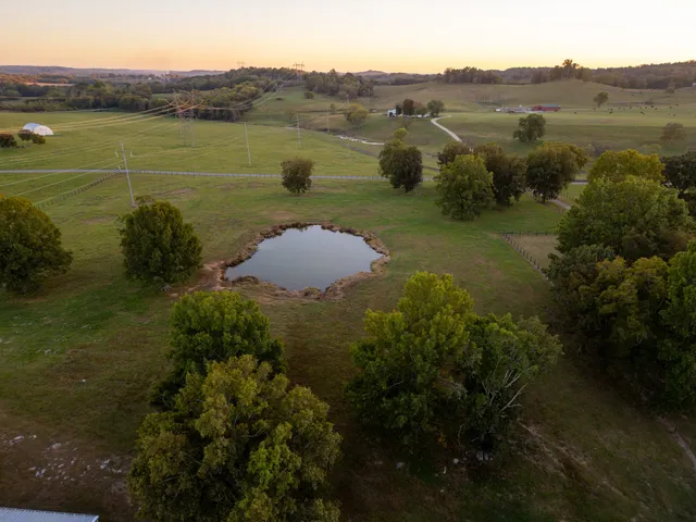 a view of a dining room with furniture a kitchen and chandelier
