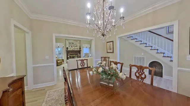 a kitchen with a sink a window and chairs