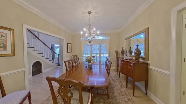 a kitchen with stainless steel appliances granite countertop a refrigerator a sink and white cabinets