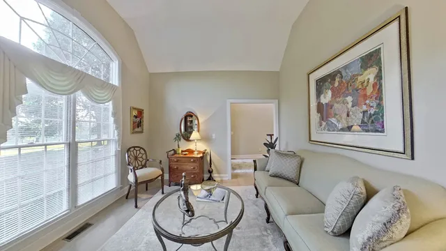 a spacious bathroom with a granite countertop sink a mirror and a bathtub
