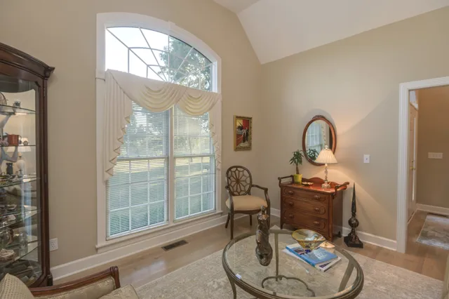 a spacious bedroom with a bed and a chandelier
