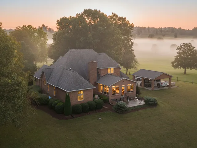 a aerial view of a house with swimming pool and big yard