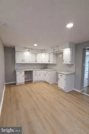 a large kitchen with a stove a sink and a refrigerator