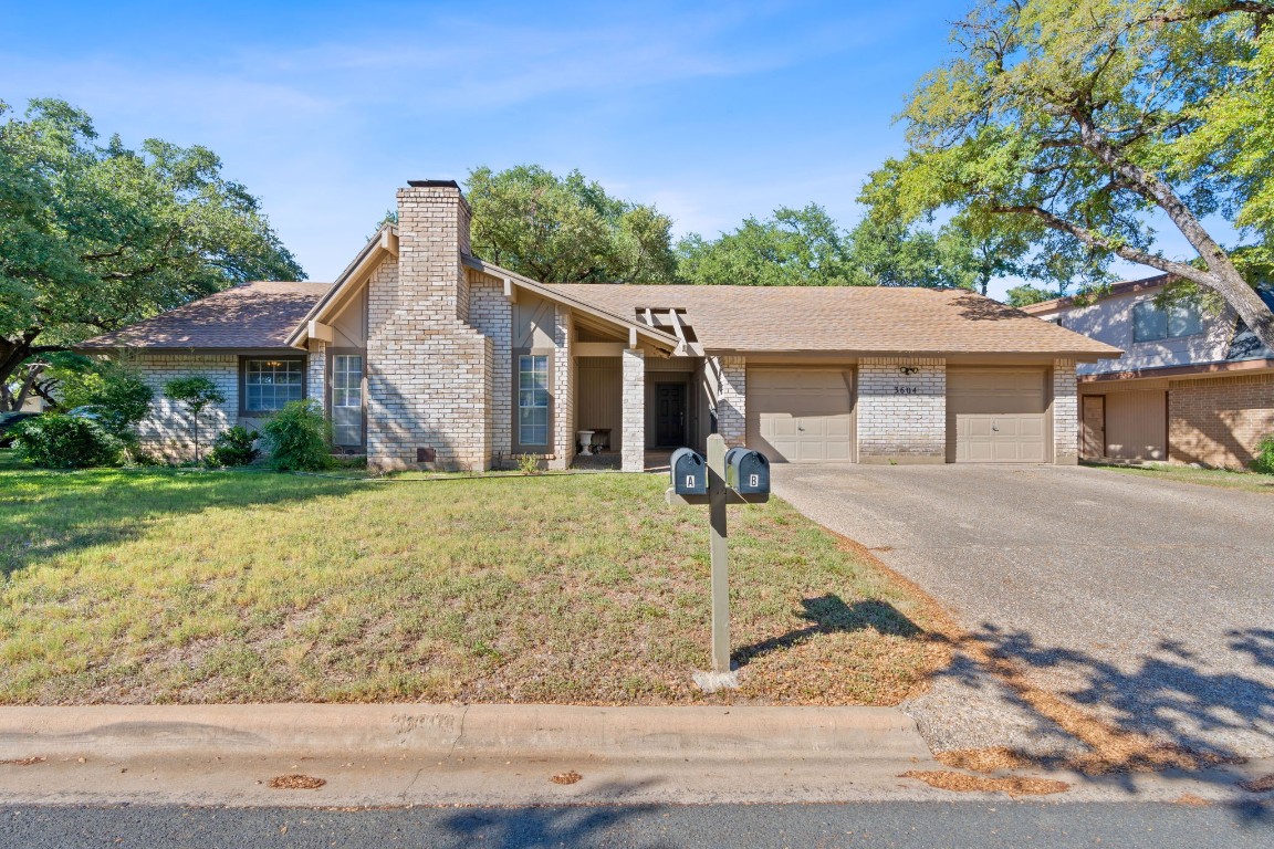 3604 Summit Bend, Unit A & B Austin, TX 78759 - Photo 1 of 1 a front view of a house with a yard