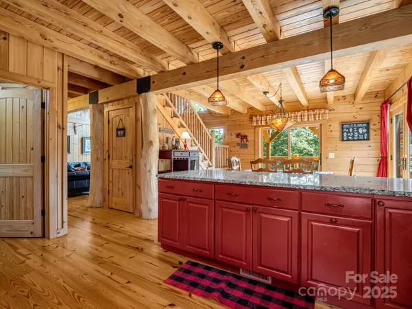 a open kitchen with stainless steel appliances granite countertop a sink and wooden cabinets
