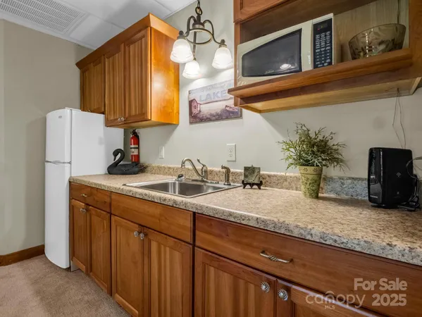 a kitchen with sink and refrigerator