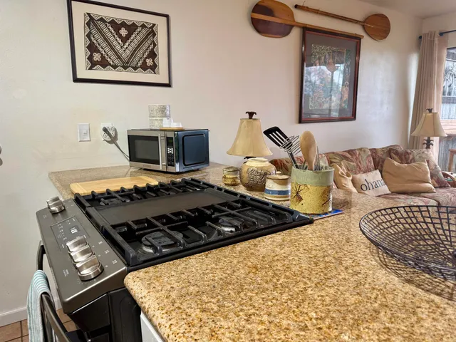 a kitchen with a sink and a stove top oven