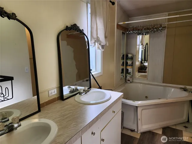 a bathroom with a double vanity sink and a mirror