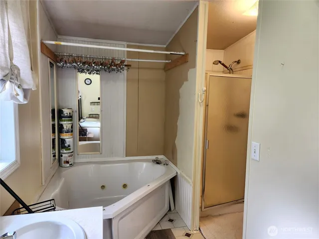 a bathroom with a tub and shower