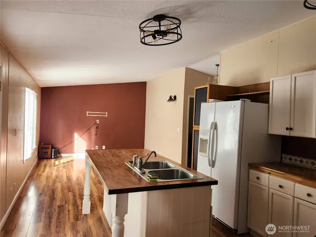 a kitchen with stainless steel appliances granite countertop a refrigerator a sink and a stove