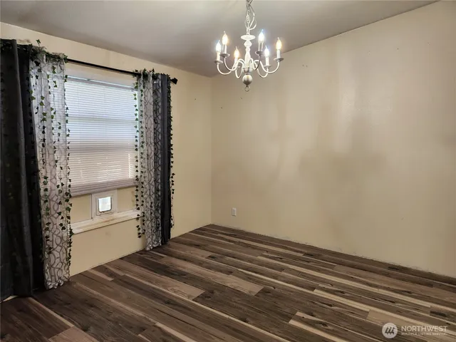 a view of a chandelier fan and wooden floor