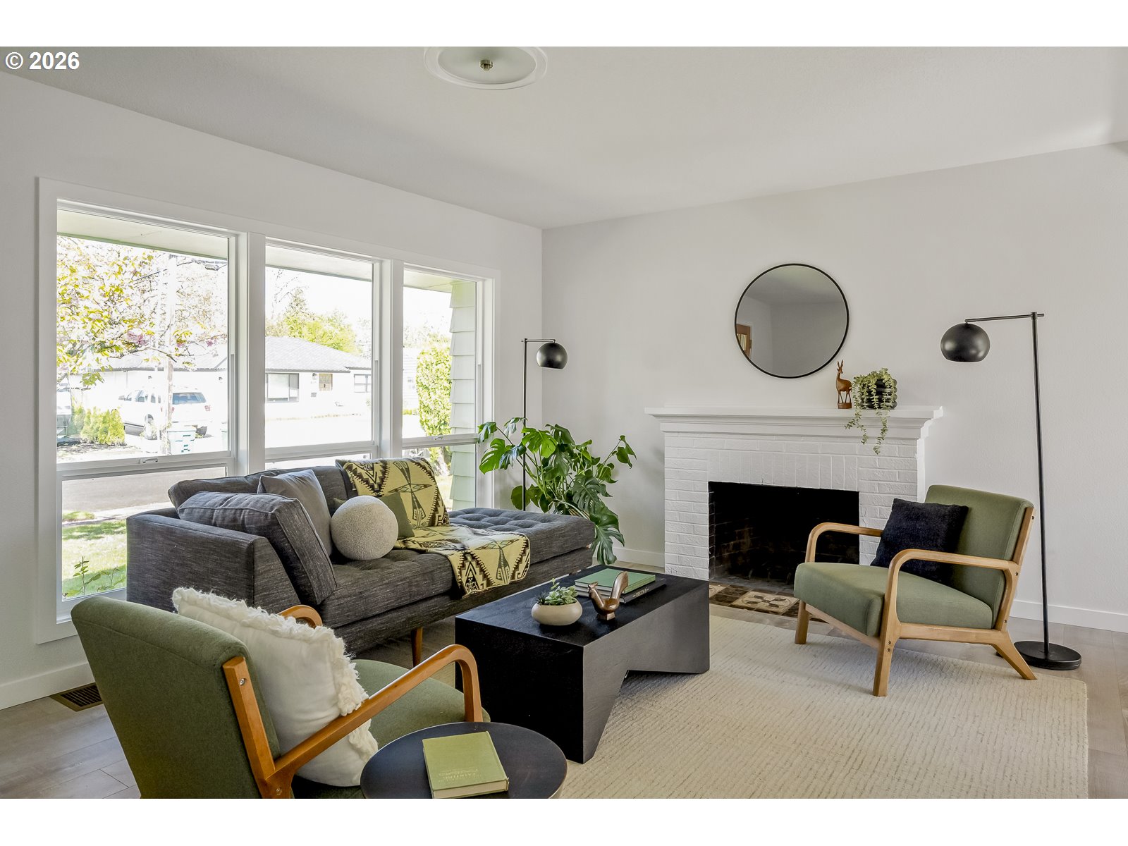 4750 Southwest Larch Drive Beaverton, OR 97005 - Photo 10 of 48 a living room with furniture a fireplace and a large window