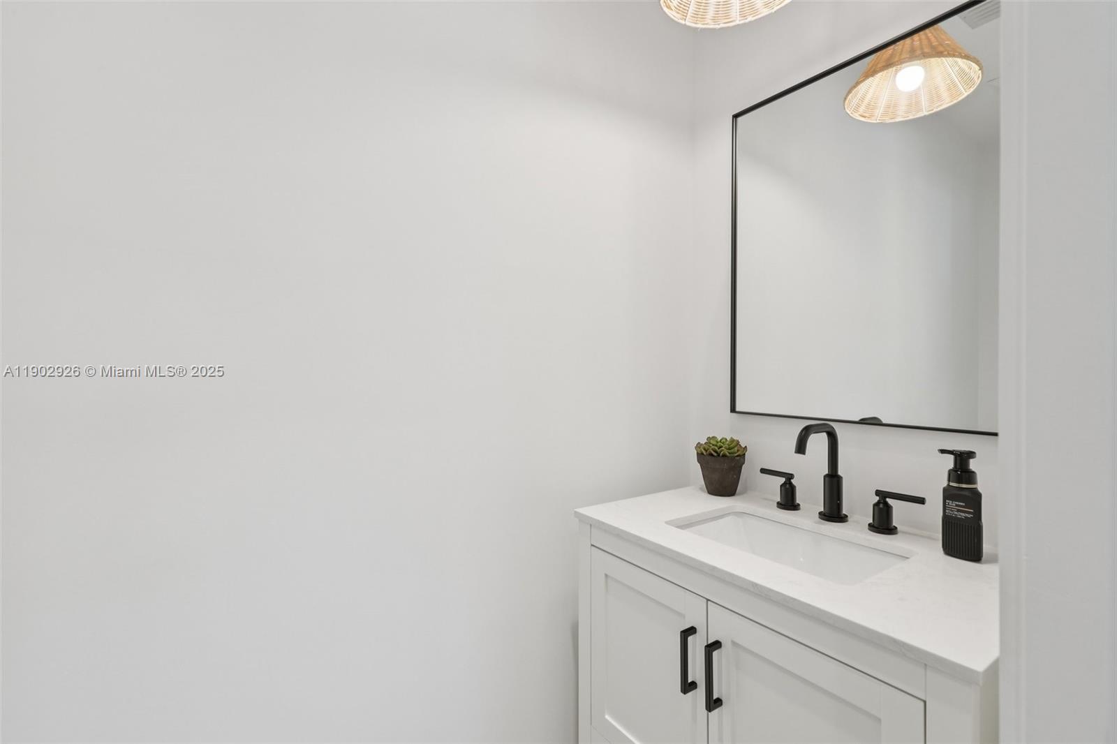 2105 Southwest 98th Avenue Miami, FL 33165 - Photo 18 of 88 a bathroom with a sink and a mirror