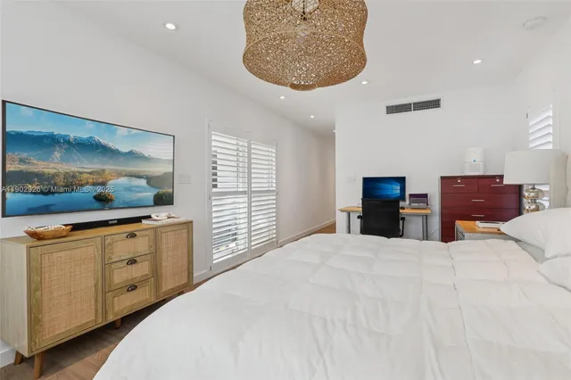 a bedroom with a large bed and a window