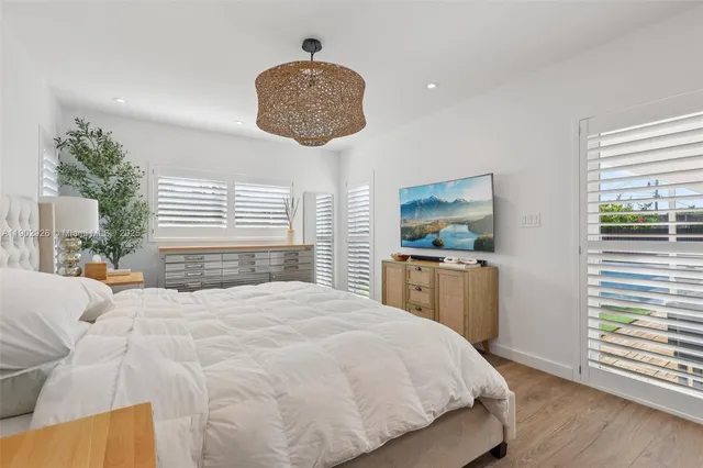 a bedroom with a bed and a flat screen tv