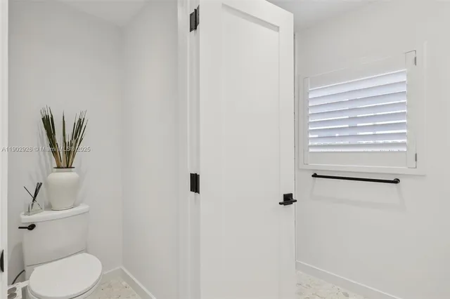 a bathroom with a double vanity sink toilet and shower