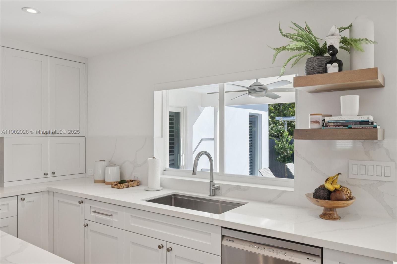 2105 Southwest 98th Avenue Miami, FL 33165 - Photo 4 of 88 a kitchen with a sink and a potted plant on the counter