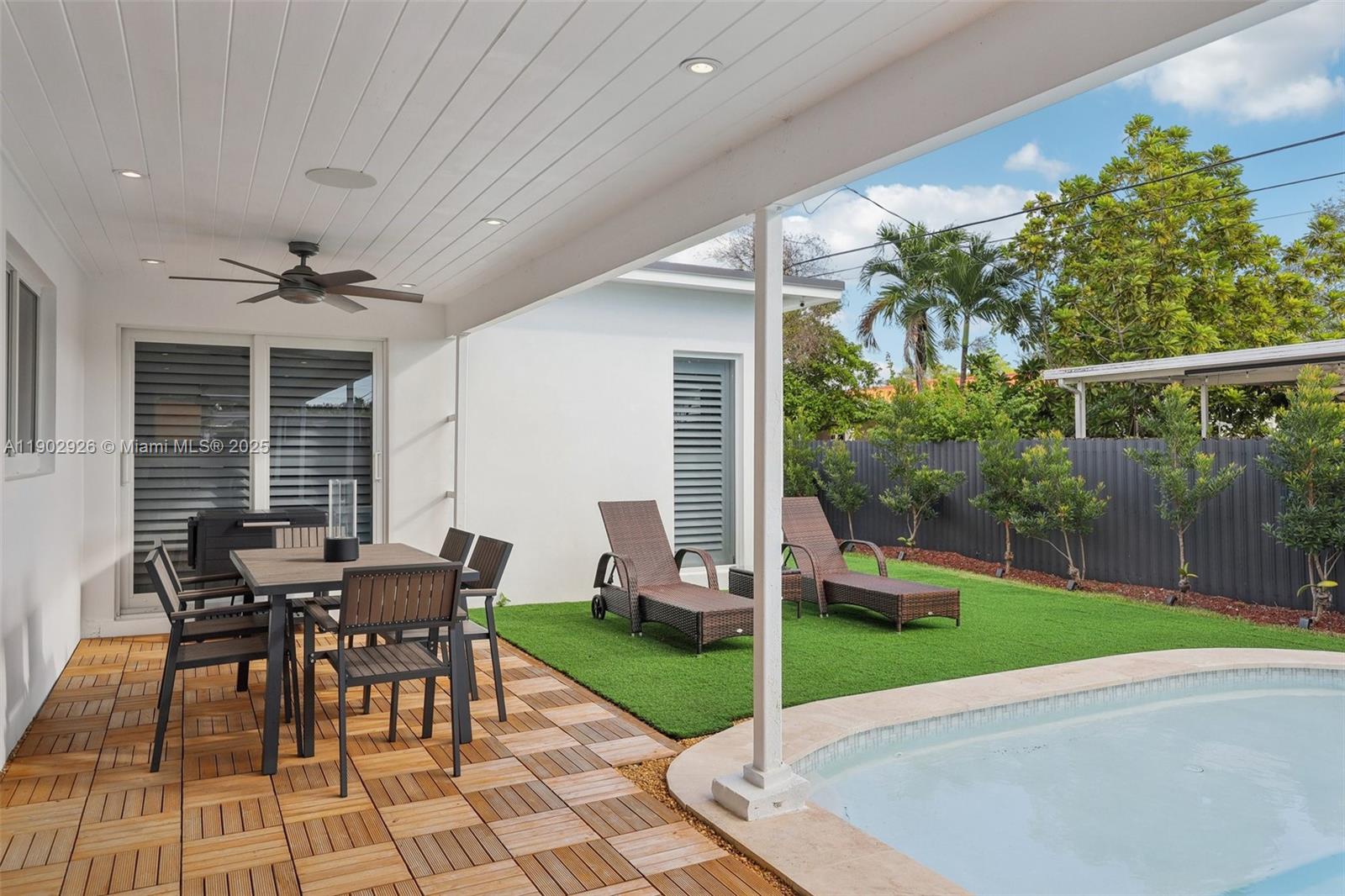 2105 Southwest 98th Avenue Miami, FL 33165 - Photo 47 of 88 a view of a patio with table and chairs floor to ceiling window with wooden fence