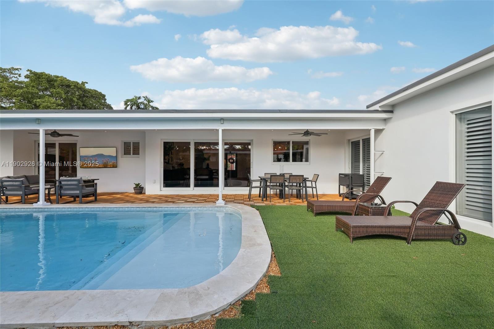 2105 Southwest 98th Avenue Miami, FL 33165 - Photo 51 of 88 a view of a house with swimming pool and porch