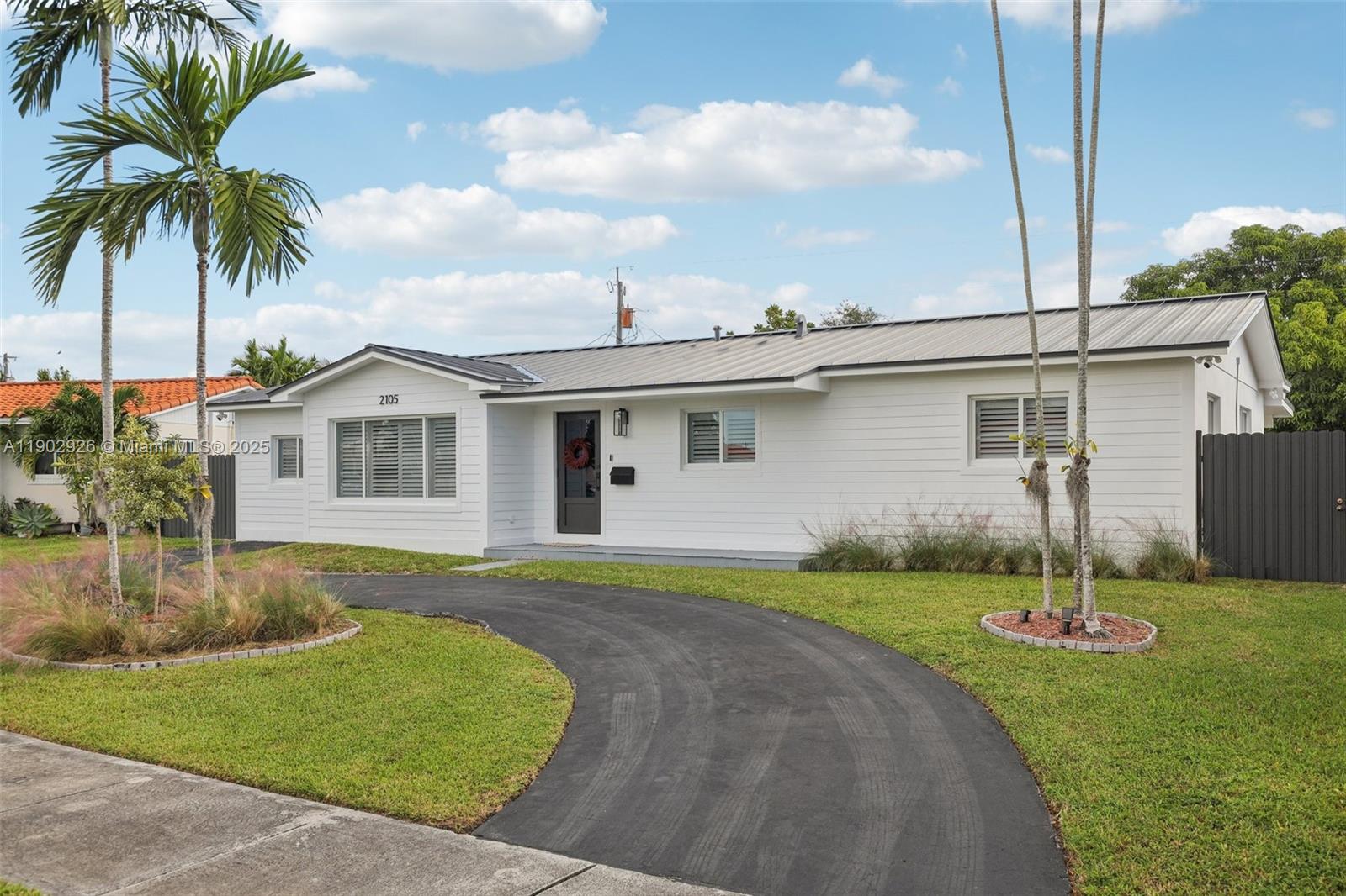 2105 Southwest 98th Avenue Miami, FL 33165 - Photo 56 of 88 a front view of a house with a yard and garage