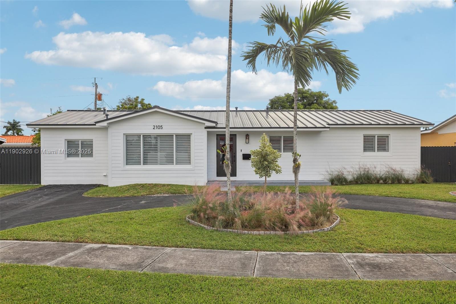 2105 Southwest 98th Avenue Miami, FL 33165 - Photo 57 of 88 a front view of a house with a garden and yard