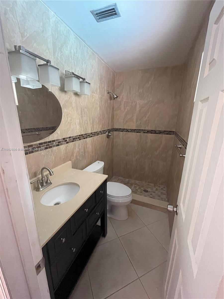 2105 Southwest 98th Avenue Miami, FL 33165 - Photo 65 of 88 a bathroom with a granite countertop sink toilet and a mirror