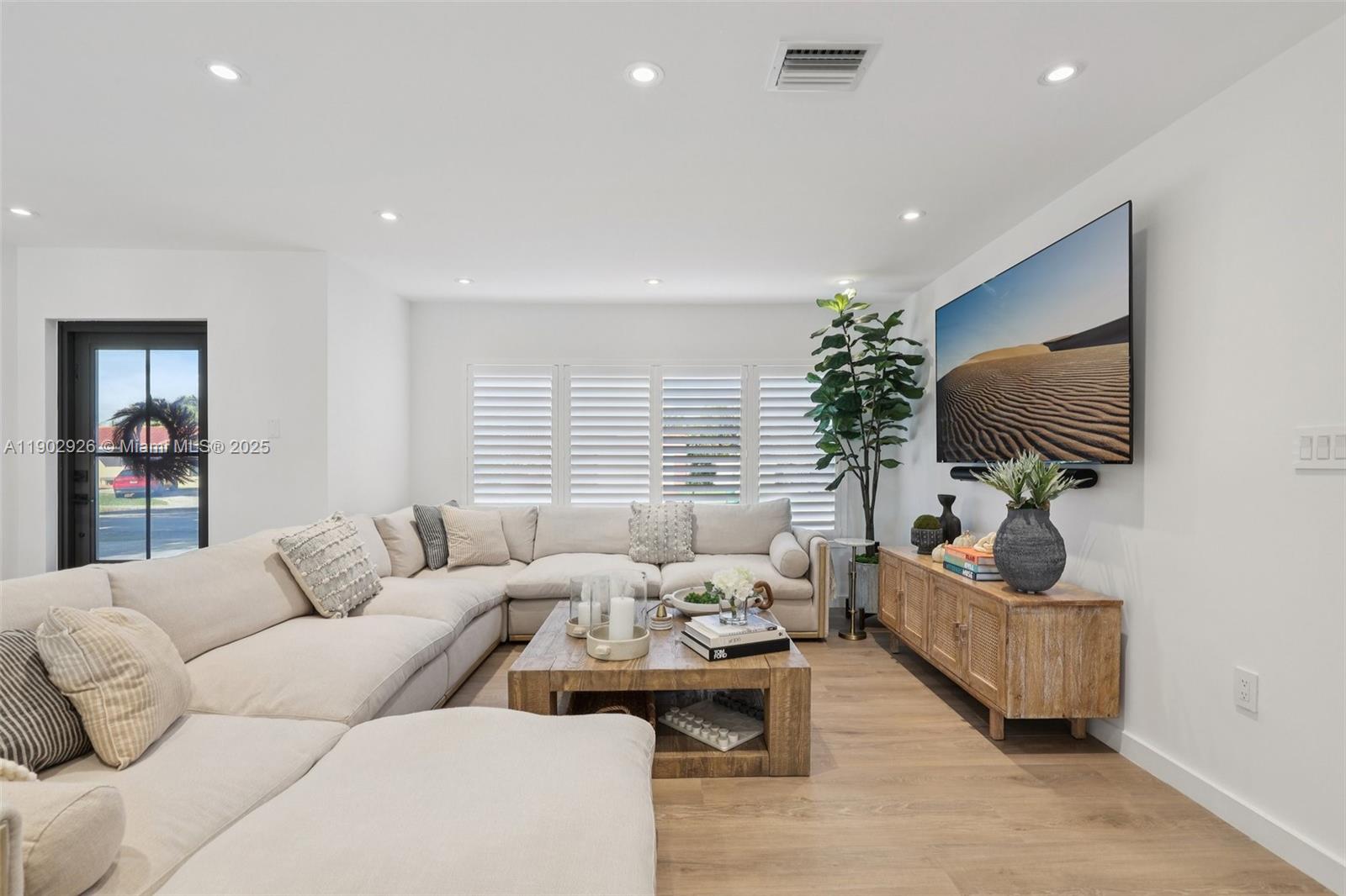 2105 Southwest 98th Avenue Miami, FL 33165 - Photo 8 of 88 a living room with furniture and a flat screen tv