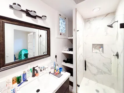 a view of storage and utility room with wooden floor